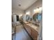 Main bathroom with double sinks, granite countertops, large mirrors, and a glass shower at 5929 Waterelm Ln, Charlotte, NC 28269
