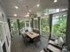 Spacious screened porch with dining set and comfortable lounge chairs overlooking the lush backyard at 5929 Waterelm Ln, Charlotte, NC 28269