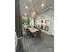 Charming screened porch with dining table, fan, and natural light, perfect for enjoying the outdoors at 5929 Waterelm Ln, Charlotte, NC 28269