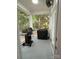 Covered screened porch featuring a grill, cover, gray epoxy flooring, and views of the backyard at 5929 Waterelm Ln, Charlotte, NC 28269