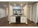 Stylish wet bar featuring white cabinets and a stainless steel wine cooler, perfect for entertaining at 5929 Waterelm Ln, Charlotte, NC 28269