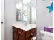 Bathroom with wood vanity, a white countertop, an oversized mirror, and a peek into the shower at 609 Atherton Way, Rock Hill, SC 29730