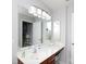 Bathroom featuring a vanity with storage, an oversized mirror with bright vanity lighting, and a peek into the tiled shower at 609 Atherton Way, Rock Hill, SC 29730