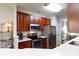 Stylish kitchen featuring stainless steel appliances and cherry cabinets at 609 Atherton Way, Rock Hill, SC 29730