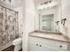 Bright bathroom features a granite vanity top, white cabinets, and a decorative shower curtain at 6221 Round Hill Rd, Charlotte, NC 28211