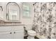Bathroom with patterned shower curtain, white trim, vanity, and decorative mirror at 6221 Round Hill Rd, Charlotte, NC 28211