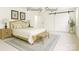 This staged bedroom is a serene oasis featuring a platform bed, a rug, and a sliding barn door at 6221 Round Hill Rd, Charlotte, NC 28211