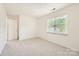 Bright bedroom features neutral carpet, white walls and trim, and natural light at 6221 Round Hill Rd, Charlotte, NC 28211