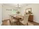 Virtually staged dining room with a wooden table, upholstered chairs, and a sideboard, offering a stylish dining experience at 6221 Round Hill Rd, Charlotte, NC 28211
