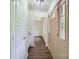 Bright foyer featuring wood-look flooring, a staircase, and a glass-paneled door, creating an inviting entrance at 6221 Round Hill Rd, Charlotte, NC 28211