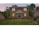 Charming brick two-story home with shutters, landscaped front yard, and inviting front entrance at 6221 Round Hill Rd, Charlotte, NC 28211