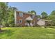 Traditional two-story home with brick facade, shutters, and green lawn creating a classic, inviting atmosphere at 6221 Round Hill Rd, Charlotte, NC 28211