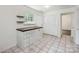 This kitchen area features a window with lots of sunlight, a built-in table, and tiled floors at 6221 Round Hill Rd, Charlotte, NC 28211