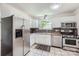 This bright kitchen features stainless steel appliances and white cabinetry providing plenty of storage space at 6221 Round Hill Rd, Charlotte, NC 28211