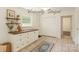 This staged kitchen area has a window with lots of sunlight, a built-in table, and tiled floors at 6221 Round Hill Rd, Charlotte, NC 28211