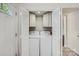 This laundry room has a washer and dryer in an open closet next to a door and tiled floors at 6221 Round Hill Rd, Charlotte, NC 28211