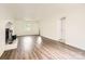 Bright living room with wood-look flooring, a brick fireplace, and a window, offering a cozy and inviting space at 6221 Round Hill Rd, Charlotte, NC 28211