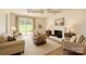 Staged living room with neutral decor, fireplace, and sliding glass doors opening to a backyard at 6221 Round Hill Rd, Charlotte, NC 28211