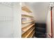 A pantry with wooden shelves holds snacks next to a wire rack and shelving unit at 6221 Round Hill Rd, Charlotte, NC 28211