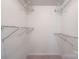 Walk-in closet with white wire shelving and neutral carpeting at 6221 Round Hill Rd, Charlotte, NC 28211