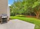 Spacious backyard includes a patio with a grill, a grassy area, and a basketball hoop at 6619 Hermsley Rd, Charlotte, NC 28278