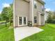 Exterior view of patio with grill, fenced yard, well-maintained lawn, and view of trees at 6619 Hermsley Rd, Charlotte, NC 28278