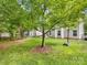 Expansive backyard boasts lush green grass and mature trees, perfect for outdoor activities at 6619 Hermsley Rd, Charlotte, NC 28278