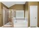 Bathroom featuring a separate shower and tub beneath a window allowing for ample natural light at 6619 Hermsley Rd, Charlotte, NC 28278