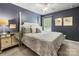 Bedroom with a four-poster bed frame, night stand, soft carpet and light grey walls at 6619 Hermsley Rd, Charlotte, NC 28278