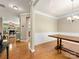 Elegant dining room with hardwood floors, a stylish chandelier, and decorative wainscoting at 6619 Hermsley Rd, Charlotte, NC 28278