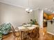 Cozy dining room features hardwood floors, a chandelier, and a round table ready for meals at 6619 Hermsley Rd, Charlotte, NC 28278