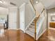 Inviting foyer with hardwood floors, a staircase, and a neutral color palette at 6619 Hermsley Rd, Charlotte, NC 28278