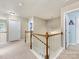 Upstairs hallway featuring carpeted floors, white trim, and access to bedrooms at 6619 Hermsley Rd, Charlotte, NC 28278