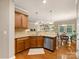 Open-concept kitchen with a breakfast bar, stainless steel appliances, and easy access to the living and dining areas at 6619 Hermsley Rd, Charlotte, NC 28278