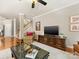 Comfortable living room with hardwood floors, ceiling fan, and entertainment center at 6619 Hermsley Rd, Charlotte, NC 28278