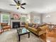 Comfortable living room with a cozy fireplace, plush seating, and access to the dining area and backyard at 6619 Hermsley Rd, Charlotte, NC 28278