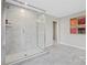 Bathroom featuring a glass enclosed shower with grey marbled walls and tile flooring, and decorative art at 7101 Short Stirrup Ln, Mint Hill, NC 28227