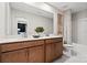 Bathroom featuring a double sink vanity with modern hardware, large mirror and separated toilet and shower at 7101 Short Stirrup Ln, Mint Hill, NC 28227