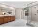 Spacious bathroom showcases a double sink vanity, large shower with glass door and natural light from a window at 7101 Short Stirrup Ln, Mint Hill, NC 28227