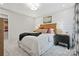 Tastefully decorated bedroom features carpet flooring, a wooden headboard, nightstands, and a window with curtains at 7101 Short Stirrup Ln, Mint Hill, NC 28227