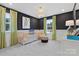 Charming Bedroom with black polka dot walls, green curtains, a comfortable crib, and a unique woven light fixture at 7101 Short Stirrup Ln, Mint Hill, NC 28227