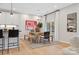 Inviting dining area with a modern table, bench seating, and stylish light fixtures at 7101 Short Stirrup Ln, Mint Hill, NC 28227