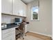 Well lit home office space with built in shelving and drawers, as well as a modern chair and a view out of the window at 7101 Short Stirrup Ln, Mint Hill, NC 28227