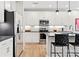 Modern kitchen with stainless steel appliances, white cabinetry, and stylish pendant lighting at 7101 Short Stirrup Ln, Mint Hill, NC 28227