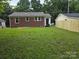 Spacious backyard with green lawn, mature trees, and a new privacy fence at 76 Sumner Nw Ave, Concord, NC 28027