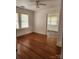 A bedroom with hardwood floors, two windows and views into another room at 76 Sumner Nw Ave, Concord, NC 28027