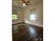 Bedroom with two windows, light walls, and wood-style flooring at 76 Sumner Nw Ave, Concord, NC 28027