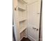 A closet with white shelving and a vintage door featuring a brass knob at 76 Sumner Nw Ave, Concord, NC 28027