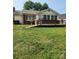 Charming home with brick and vinyl siding, a large deck, and a grassy front yard at 76 Sumner Nw Ave, Concord, NC 28027