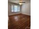 Open living space featuring hardwood flooring and a ceiling fan with light at 76 Sumner Nw Ave, Concord, NC 28027